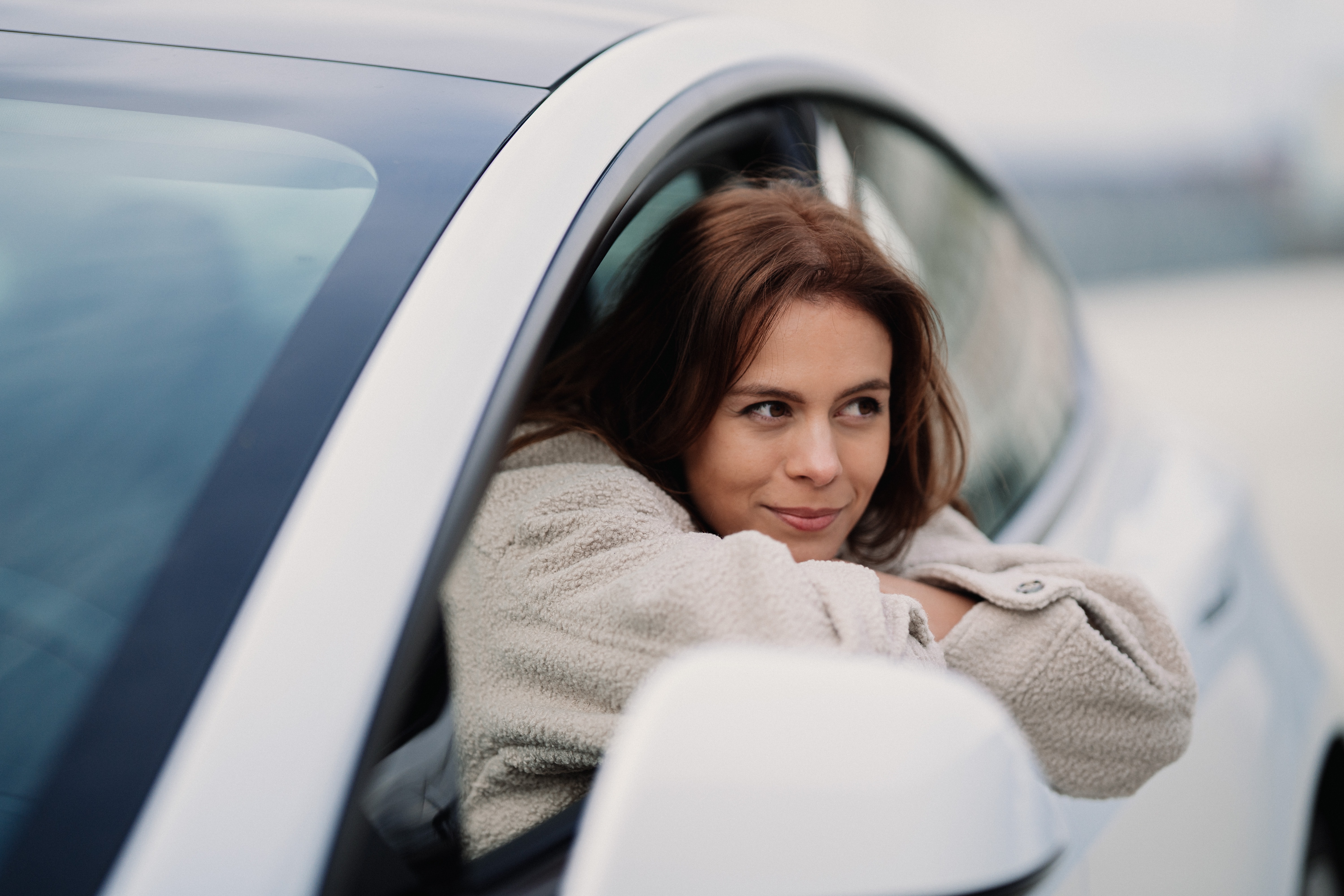 Girl smiling in white Tesla car